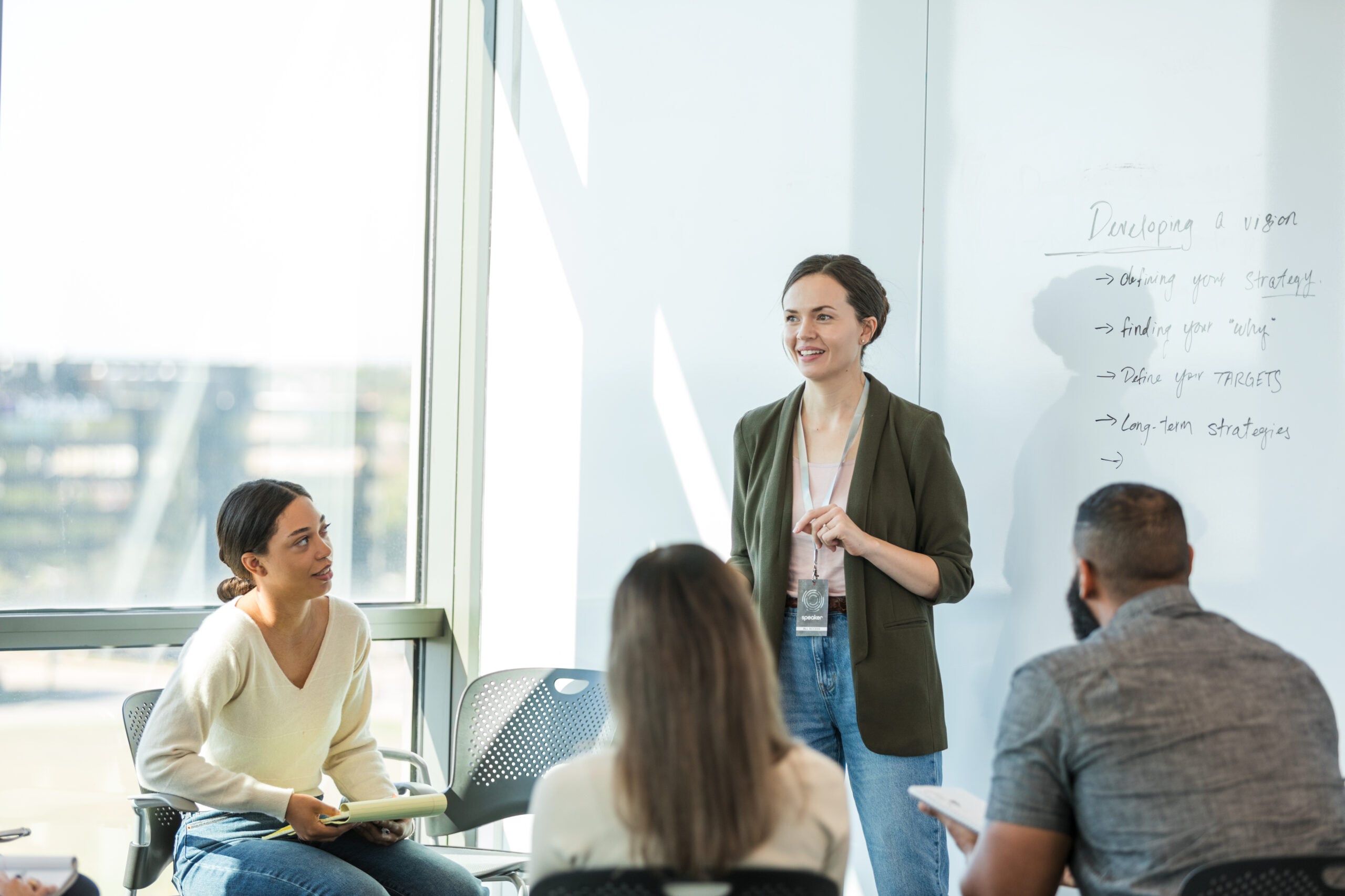 Faculty member presenting to colleagues. (Getty Images)