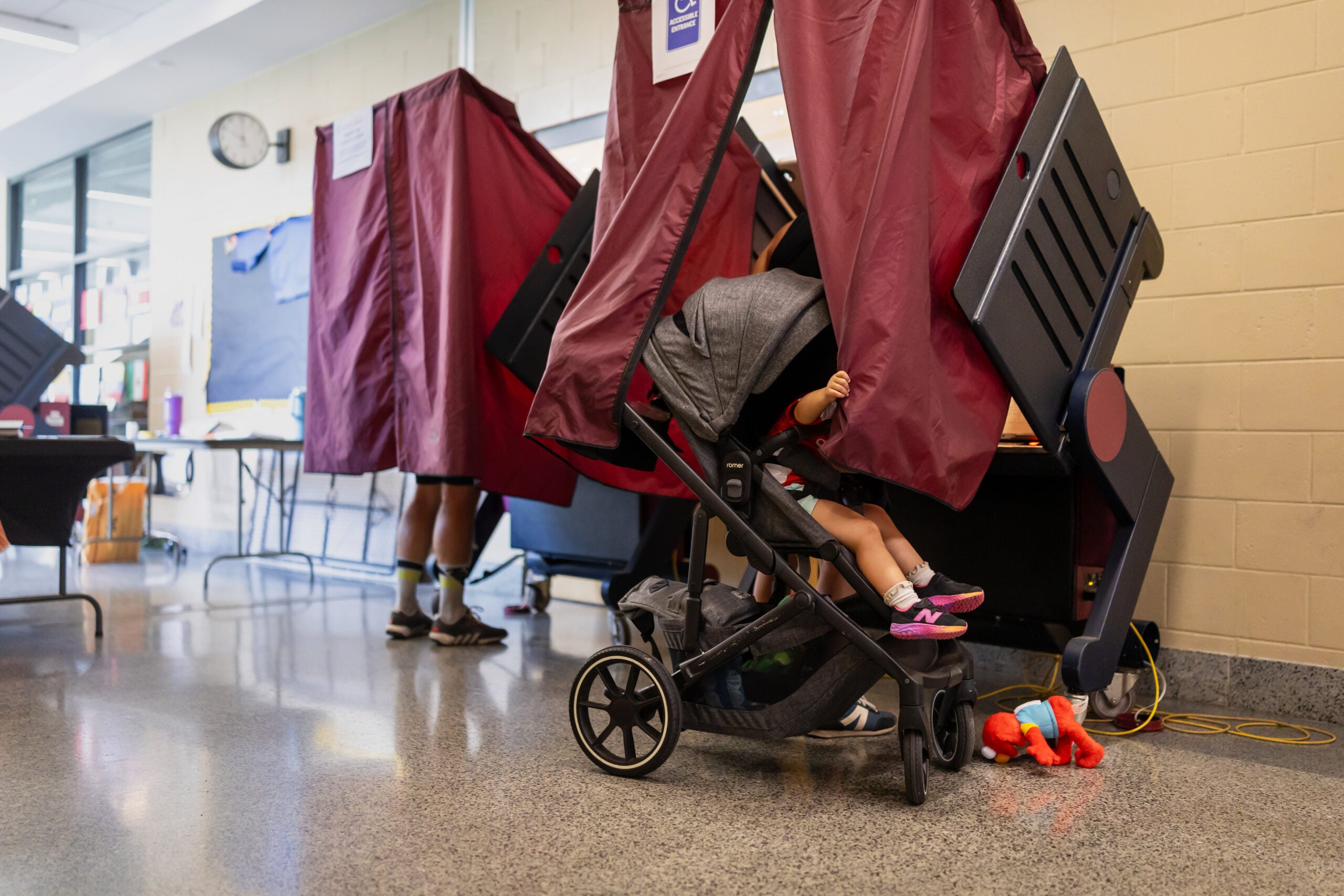 NEW ORLEANS, LOUISIANA - MAY 16: A young child waits for her mom, Antoinette Abboud to finish voting after dropping her toy at Phillis Wheatley Community School on Primary Election Day in New Orleans, Louisiana. Louisiana voters are going to the polls to help decide both party primary races for U.S. Senator as well as five proposed state constitutional amendments. (Photo by Kathleen Flynn/Getty Images)