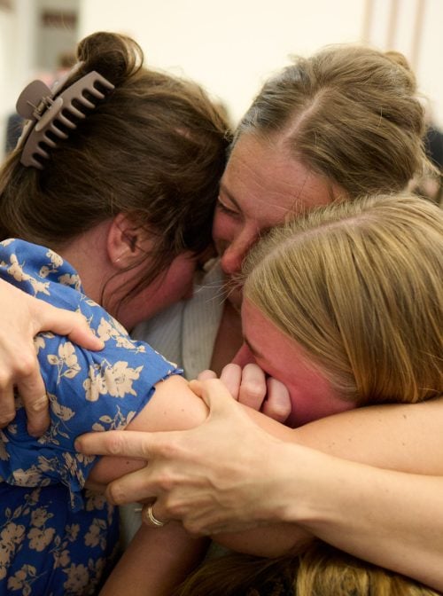 Members of the Grand Blanc, Michigan, congregation of The Church of Jesus Christ of Latter-day Saints embrace each other following the meeting with Elder David A. Bednar of the Quorum of the Twelve Apostles on Tuesday, September 30, 2025, following the deadly shooting and fire that claimed four lives and injured eight others at a local meetinghouse of The Church of Jesus Christ of Latter-day Saints. (2025 by Intellectual Reserve, Inc. All rights reserved.)