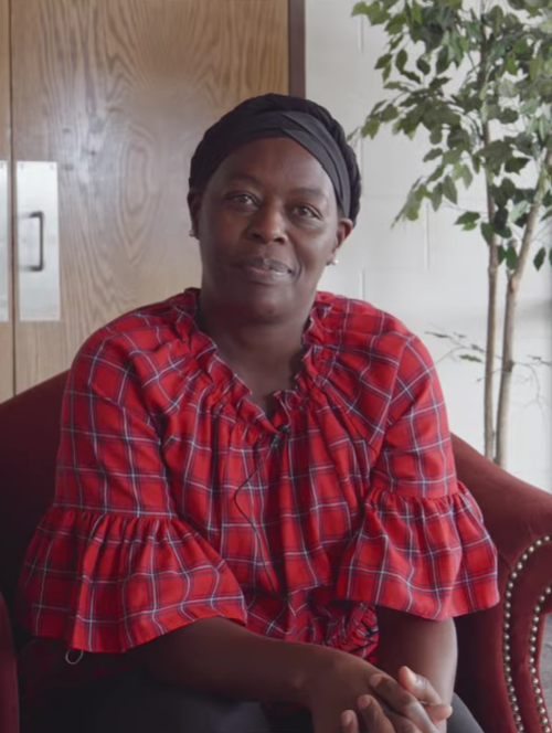 Everlyne Lagat, Community Liason for Swahili Group at the Catholic Charities Archdiocese of Santa Fe, speaks to the camera.