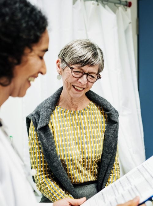 A clinical doctor going over test results with a patient at the hospital. (Tom Werner/Getty Images)