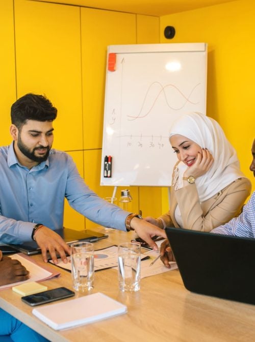 Colleagues working together and discussing  work in the office. (Evgeniia Siiankovskaia/Getty)
