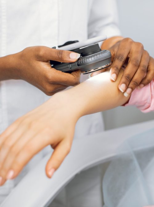 Dermatologist examining patient's skin. (iStock / Getty Images Plus)