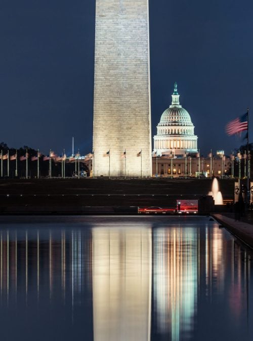 The US Capitol Building with Washington Monument with US flag The US Capitol Building with Washington Monument with US flag