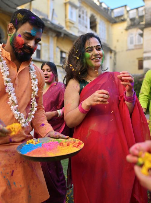 People dancing and celebrating Holi festival with a plate full of colors. Holi is a Hindu festival, a festival of colors. (Mayur Kakade/Getty Images)