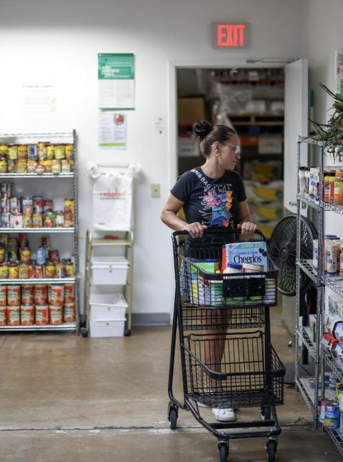 Ester Pena shops at the Feeding South Florida food pantry on October 27, 2025 in Pembroke Park, Florida.