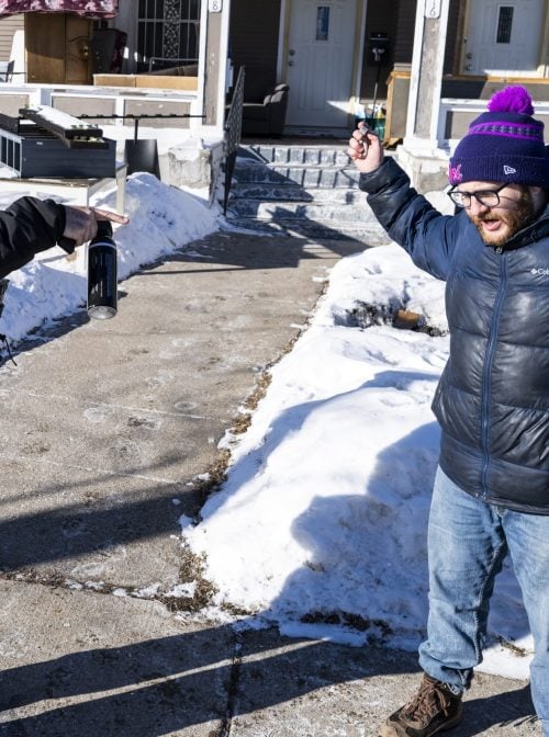 MINNEAPOLIS, MINNESOTA - JANUARY 28: An observer confronts an ICE agent as they knock on the door of a residence on January 28, 2026 in Minneapolis, Minnesota. DHS continues its immigration enforcement operations after the killings of Alex Pretti and Renee Nicole Good by federal law enforcement.  (Photo by Stephen Maturen/Getty Images)