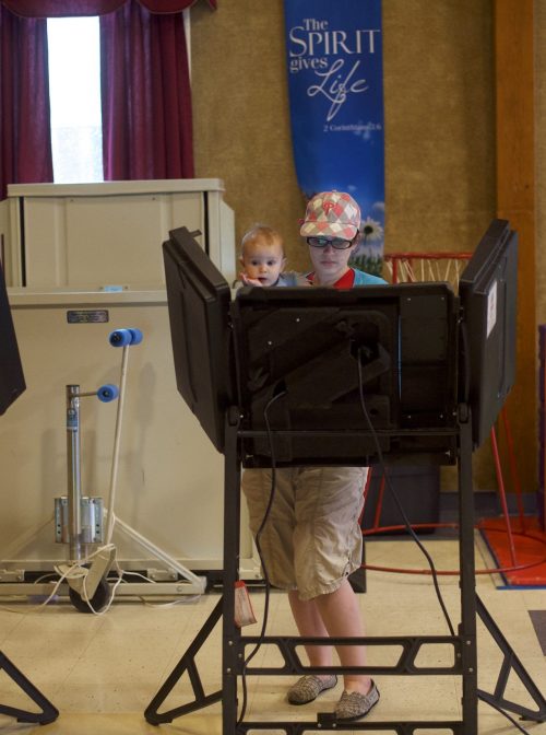 TRUCKSVILLE, PA - MAY 15:  (C) Elisabeth Ford, 33, holds her son, while casting her vote at the Trucksville United Methodist Church polling station during the 2018 Pennsylvania Primary Election on May 15, 2018 in Trucksville, Pennsylvania.  (Photo by Mark Makela/Getty Images)