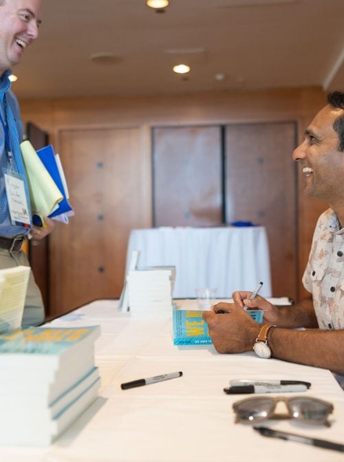 Eboo Patel signs a copy of We Need to Build: Field Notes for Diverse Democracy at the 2023 Interfaith Leadership Summit.