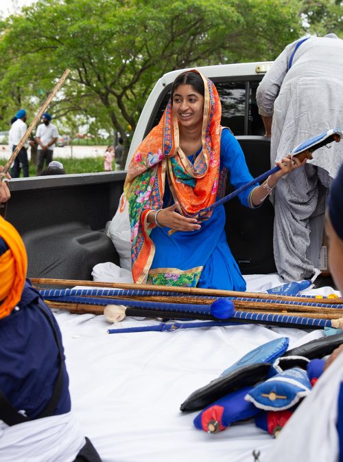 Jasmeen Kaur and other members of the Sikh Religious Society of Palatine prepare to participate in the Parade of Faiths in downtown Chicago on August 13, 2023. The parade preceded the Parliament of the World's Religions, which began August 14. Photo by Lauren Pond for RNS
