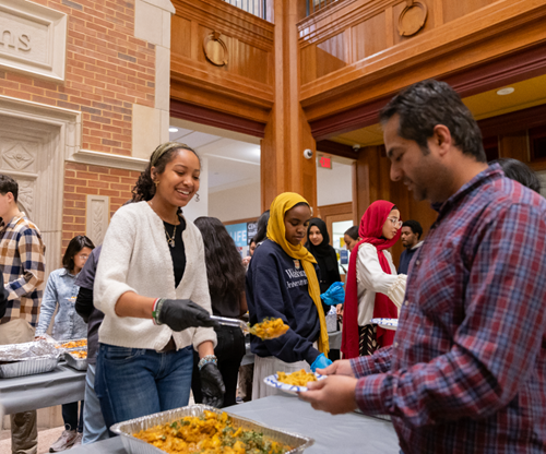 Students serve their peers at the interfaith iftar. Photo credit: Yiwen Zha
