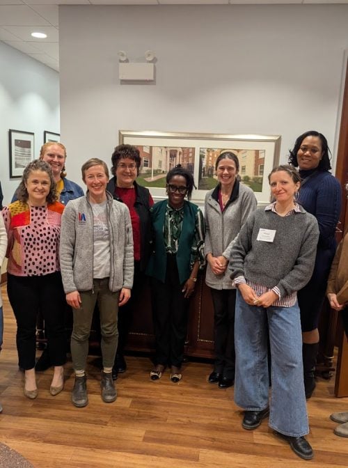 Volunteers from Catholic Charities of the Archdiocese of Chicago, Habitat for Humanity of Chicago, YMCA of Metropolitan Chicago and Interfaith America pose together after serving a hot meal to 140 community members as part of the Team Up Project.