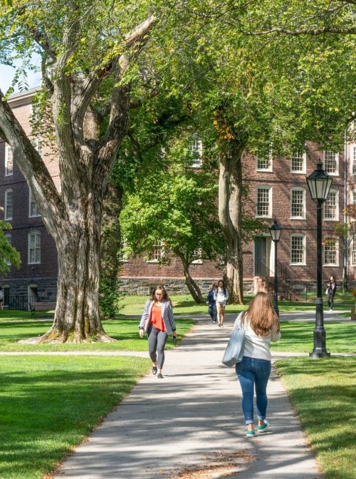 PROVIDENCE, RI/USA - SEPTEMBER 30, 2019:   Unidentfied individuals, and University Hall  on the campus of Brown University. (Shutterstock/Ken Wolter)