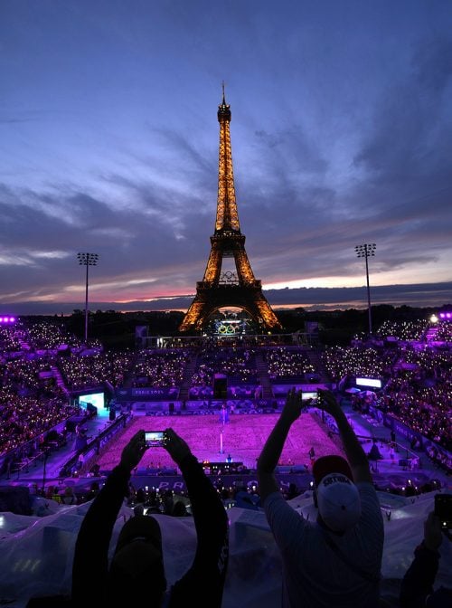 Spectators take photos at Eiffel Tower Stadium during the 2024 Summer Olympics, Saturday, July 27, 2024, in Paris, France. (AP Photo/Robert F. Bukaty)
